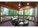 Inviting screened-in porch with wood ceilings, ample seating, and views of the surrounding trees at 830 Lee Nw Dr, Marietta, GA 30060