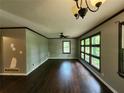 View of a spacious living room featuring hardwood floors, neutral paint and natural light from large windows at 1321 Snapfinger Rd, Decatur, GA 30032