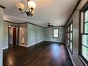 Spacious living room featuring dark hardwood floors, neutral paint, large windows and a ceiling fan at 1321 Snapfinger Rd, Decatur, GA 30032