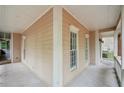 Covered front porch with neutral siding, white columns and trim, and ample space for seating at 2650 Wendell Creek Ln, Snellville, GA 30039