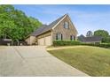 A well-maintained home with a spacious driveway and a lush green lawn at 2656 White Rock Dr, Buford, GA 30519