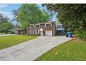 Classic two-story brick home featuring a wide driveway and bright white trim at 2911 Allegro Nw Dr, Atlanta, GA 30318