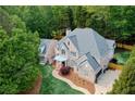 An aerial view shows a beautiful home with lush landscaping and a large driveway at 2930 Burnt Hickory Nw Rd, Marietta, GA 30064