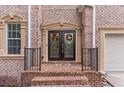 Close-up of a brick home's entrance, highlighting the double doors with decorative wreaths at 3113 Brians Creek Se Dr, Conyers, GA 30013