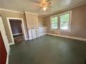 Spacious living room featuring a ceiling fan, fireplace, and plenty of natural light at 39 N Broad St, Covington, GA 30014