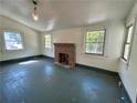 Sun-lit living area featuring a classic fireplace, and windows providing a bright airy space at 39 N Broad St, Covington, GA 30014