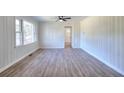 Bright living room boasting vinyl flooring, a ceiling fan, and a picturesque view from the window at 4551 Salem Rd, Covington, GA 30016