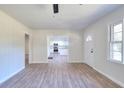 Spacious living room with view of kitchen, modern vinyl flooring, and well-lit with natural light at 4551 Salem Rd, Covington, GA 30016