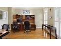 Spacious home office with hardwood floors and built-in shelving, perfect for working from home at 5595 Timson Ln, Johns Creek, GA 30022