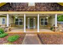 Inviting front porch with wooden porch swings, white columns, and a decorative front door with floral wreath at 72 Griggs Sw St, Marietta, GA 30064