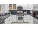 Well-equipped kitchen featuring stainless steel appliances, granite countertops, and sleek white cabinetry at 850 Piedmont Ne Ave # 1409, Atlanta, GA 30308