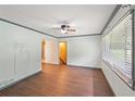 Bright living room featuring wood floors, a ceiling fan, and natural light from the large window at 2823 Connally Sw Dr, Atlanta, GA 30311