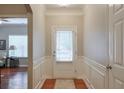 Bright entryway featuring a stylish door, wood floors, and elegant molding at 973 Duncan Ter, Canton, GA 30115