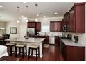 Modern kitchen featuring granite countertops, stainless steel appliances, and a large island with seating at 973 Duncan Ter, Canton, GA 30115