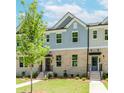 Beautiful townhome featuring a brick facade, manicured lawn, and inviting entrance at 1242 Ainsworth Aly # 40, Sugar Hill, GA 30518