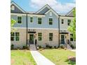 Attractive townhome showcasing a brick front, landscaped lawn, and welcoming front steps at 1242 Ainsworth Aly # 40, Sugar Hill, GA 30518