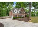 Beautiful brick home with a side entry garage, lush landscaping, and large driveway at 4442 Freeman Rd, Marietta, GA 30062