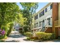 Lovely townhome with a private entrance framed by lush greenery and mature trees along a private drive at 104 Terrace Ne Dr # 1, Atlanta, GA 30305