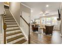 Inviting entryway with staircase leading to the upper level, hardwood floors and a view to the living area at 120 Maple Creek Way, Woodstock, GA 30188