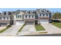 Exterior view of charming townhomes with garages and landscaped front yards at 120 Maple Creek Way, Woodstock, GA 30188