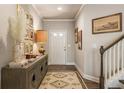 Inviting foyer with wood floors, stylish decor, and staircase at 120 Maple Creek Way, Woodstock, GA 30188