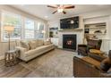Bright living room with fireplace, built-in bookshelves and stylish furnishings at 120 Maple Creek Way, Woodstock, GA 30188