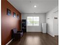 Cozy living room with hardwood floors, a chair, and warm-toned accent wall, creating a relaxing atmosphere at 435 Noblewood Dr, Mcdonough, GA 30252