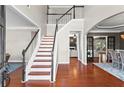 Elegant foyer with hardwood floors, staircase, and views into other living spaces at 920 Pebblestone Ct, Alpharetta, GA 30009