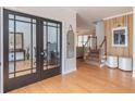 Welcoming foyer with wood floors, stairs, and glass paneled office doors at 1004 Spruce Creek Ln, Lawrenceville, GA 30045