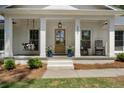 Inviting front porch featuring rocking chairs and swing at 250 Hembree Rd, Roswell, GA 30075