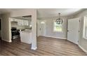 Open floor plan kitchen with white cabinets, granite countertops, and stainless steel appliances at 3706 Larkspur Ter, Decatur, GA 30032
