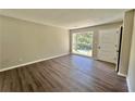 Open living room featuring a large window with natural light and wood-look floors at 3706 Larkspur Ter, Decatur, GA 30032