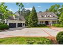 Estate featuring a main house and detached garage, with beautiful landscaping and a spacious driveway at 5122 Cantrell Se Pt, Acworth, GA 30101