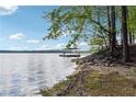 Picturesque waterfront with a dock on a sunny day, providing a serene setting for relaxation and recreation at 5122 Cantrell Se Pt, Acworth, GA 30101