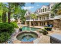 Backyard paradise with a luxurious pool, spa, stone patio, and outdoor fireplace, perfect for entertaining at 5122 Cantrell Se Pt, Acworth, GA 30101