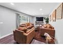 Inviting living room with wood-look floors, recessed lighting, and comfortable, modern furnishings at 7371 Ovis Ct, Riverdale, GA 30274