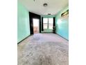 Carpeted bedroom with black accent wall, natural light, and a balcony at 898 Oak Sw St # 1418, Atlanta, GA 30310