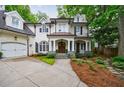 Elegant white brick home featuring a columned front porch and a neatly landscaped yard at 1412 Lanier Ne Mnr, Atlanta, GA 30319