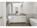 Modern bathroom with double vanity, soaking tub, and a glass enclosed shower with marble accents at 241 Maynard Se Ter # 18, Atlanta, GA 30316