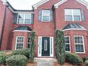 Close-up of the front entrance featuring brick facade and a decorative front door at 5584 Dendy Trce, Fairburn, GA 30213