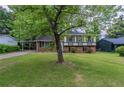 Traditional split-level home with well-kept lawn and mature trees in a quiet neighborhood at 8431 Magnolia Dr, Jonesboro, GA 30238