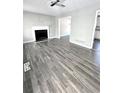 Bright living room featuring a fireplace, modern gray floors, light-colored walls, and recessed lighting at 4872 Lewis Rd, Powder Springs, GA 30127