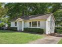 Front yard of a traditional home with a well-kept lawn and a charming facade at 176 Nancy Se Dr, Marietta, GA 30067