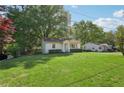 Single story home on a large lot with mature trees and a well-manicured lawn at 176 Nancy Se Dr, Marietta, GA 30067