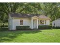 Traditional brick home with a neat, green lawn and manicured bushes at 176 Nancy Se Dr, Marietta, GA 30067