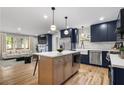 Modern kitchen featuring an island, stainless steel appliances, and hardwood floors at 1835 Hawkins Se St, Smyrna, GA 30080