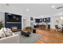Open-concept living space featuring fireplace, kitchen with island, and dining area at 1835 Hawkins Se St, Smyrna, GA 30080