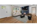 Bright living room featuring a fireplace with a blue accent wall and hardwood floors at 1835 Hawkins Se St, Smyrna, GA 30080