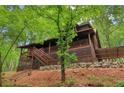 Beautiful log cabin with a spacious front porch and natural wood accents at 2361 Mann Rd, Douglasville, GA 30134