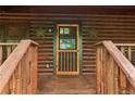 Charming log cabin entrance with a decorative door and rustic star accents at 2361 Mann Rd, Douglasville, GA 30134